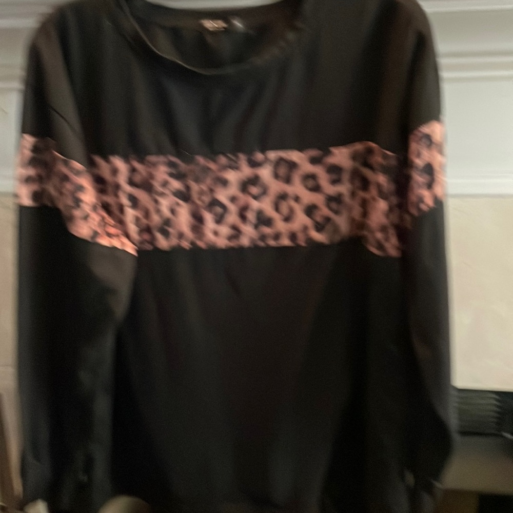 Black cotton top with leopard trim. Long sleeve. Trim across front